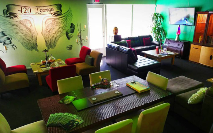 A cannabis friendly lounge painted in green and with comfortable couches.