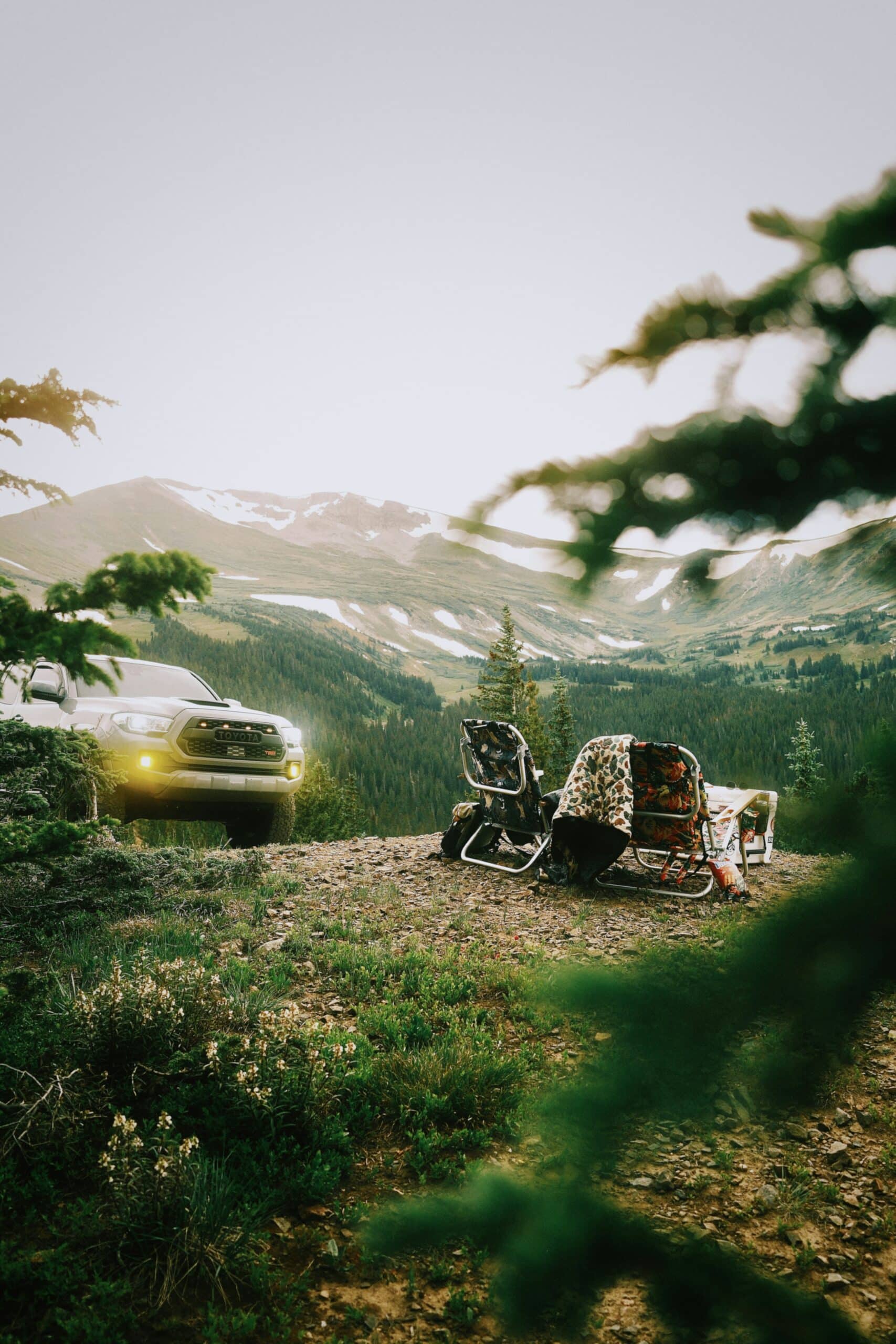truck parked next to camp site with mountain views